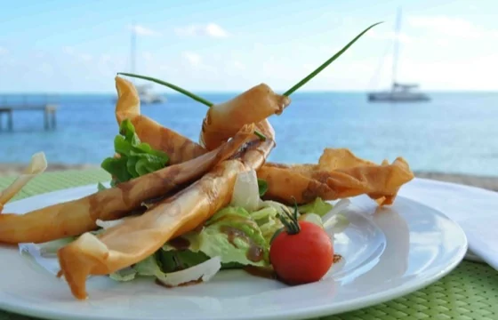 Une entrée avec pièces croustillantes, salade et tomate, face au lagon, au restaurant du Mahana.